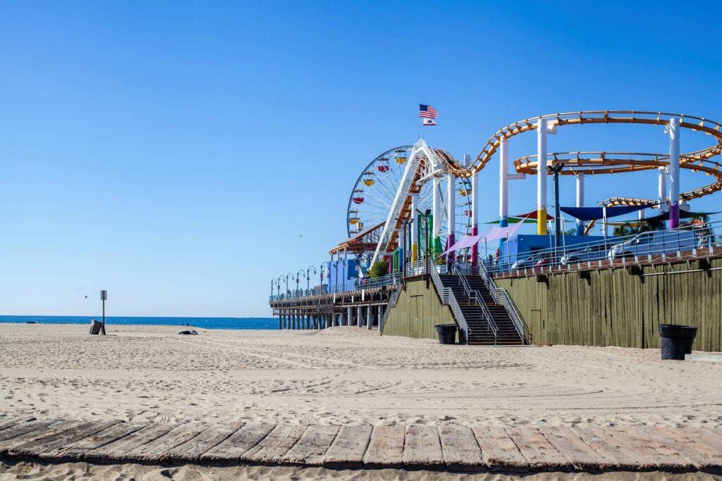 A shot of the roller coaster at Pacific Park from the beach on Santa Monica Pier.