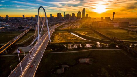 A view of downtown Dallas, TX, from the Margaret Hunt Hill Bridge at sunset.