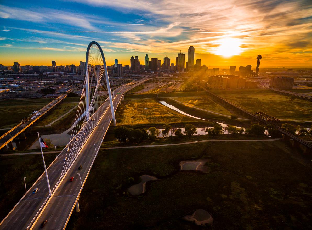 A view of downtown Dallas, TX, from the Margaret Hunt Hill Bridge at sunset.