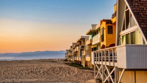 Idyllic houses lined up on the beach in Oxnard, CA.