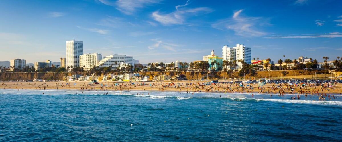 Santa Monica beach with building and Pacific ocean view from pier.
