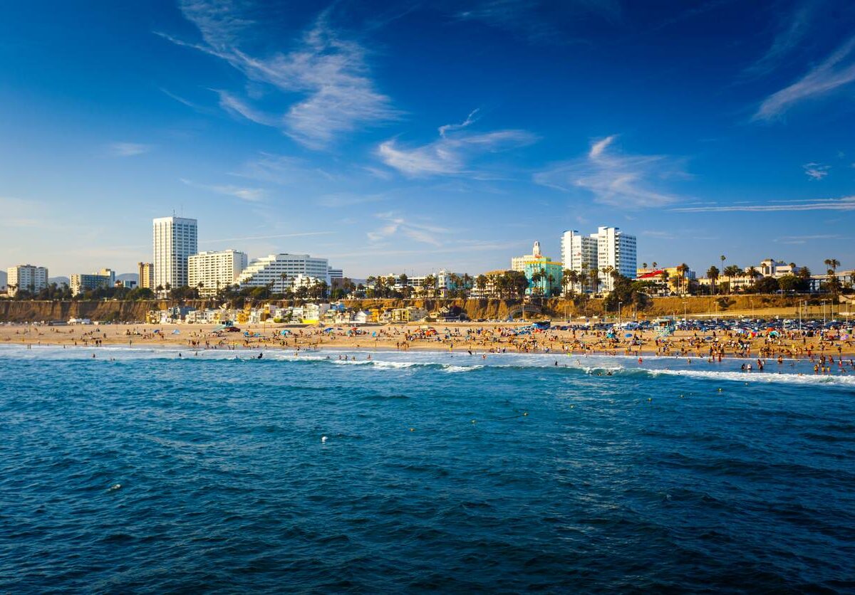 Santa Monica beach with building and Pacific ocean view from pier.