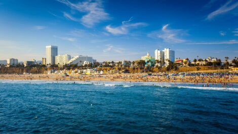 Santa Monica beach with building and Pacific ocean view from pier.