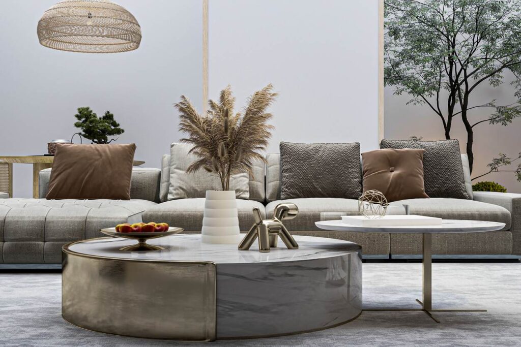 A living room staged with throw pillows, a fruit bowl, and a clean carpet.