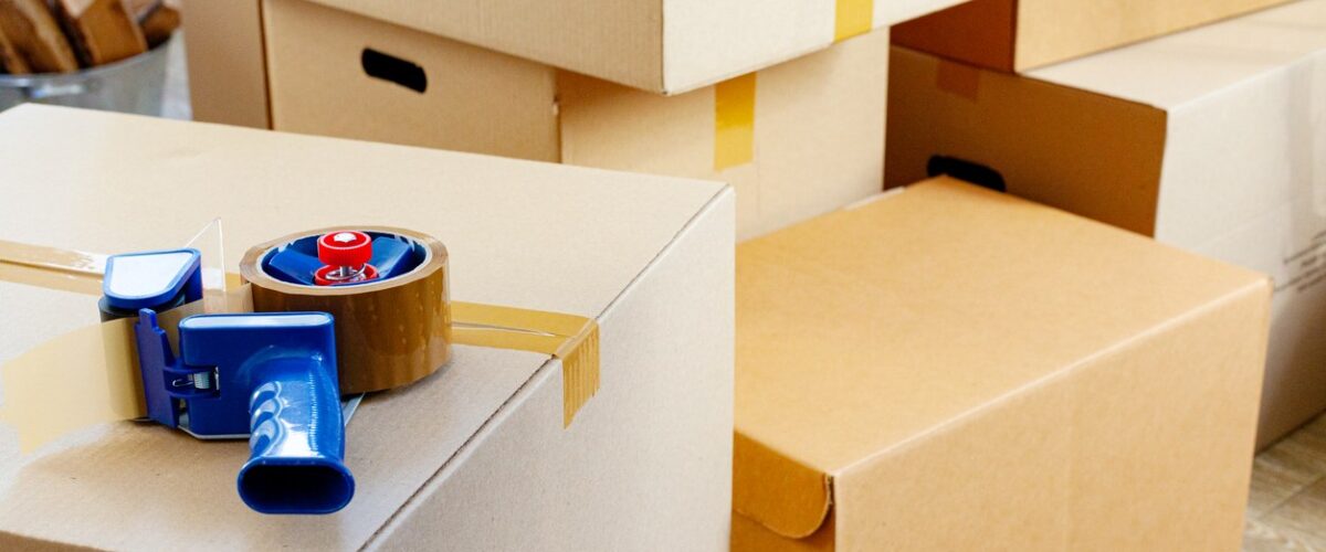 A storage unit packed with taped boxes sits ready to be organized.