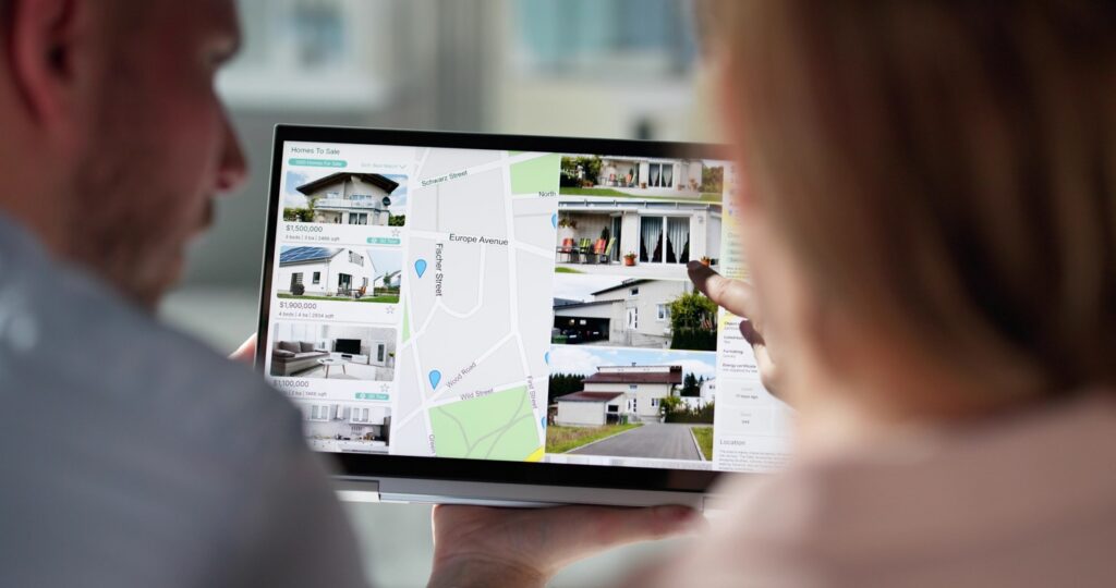 A couple explores homes for sale online to find the right price for their home.